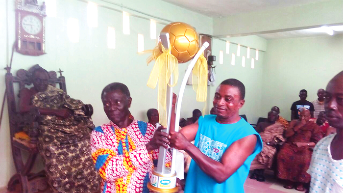   former Chairman of Okwawu United Mr R.K. Appiah and the team’s coach Ibrahim Merigah (right) admiring the trophy